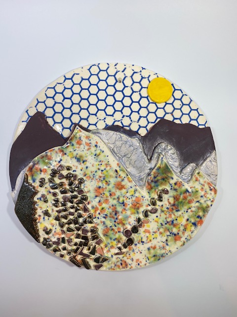 Round landscape-inspired ceramic wall piece