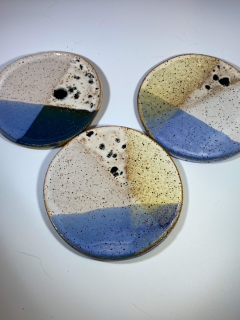 Small blue ceramic coasters grouped together