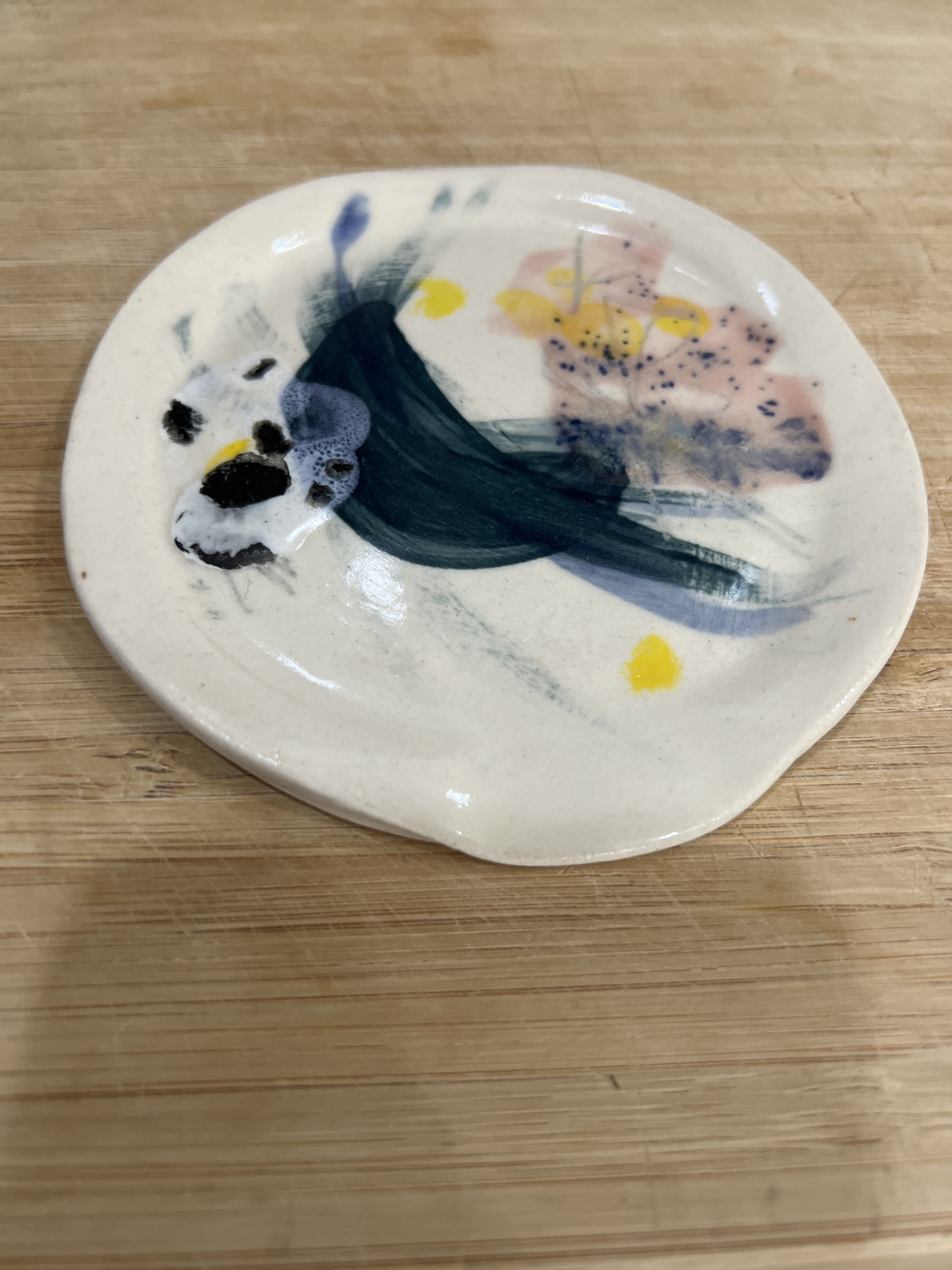 Ceramic wall vase with colorful cutouts and dried flowers