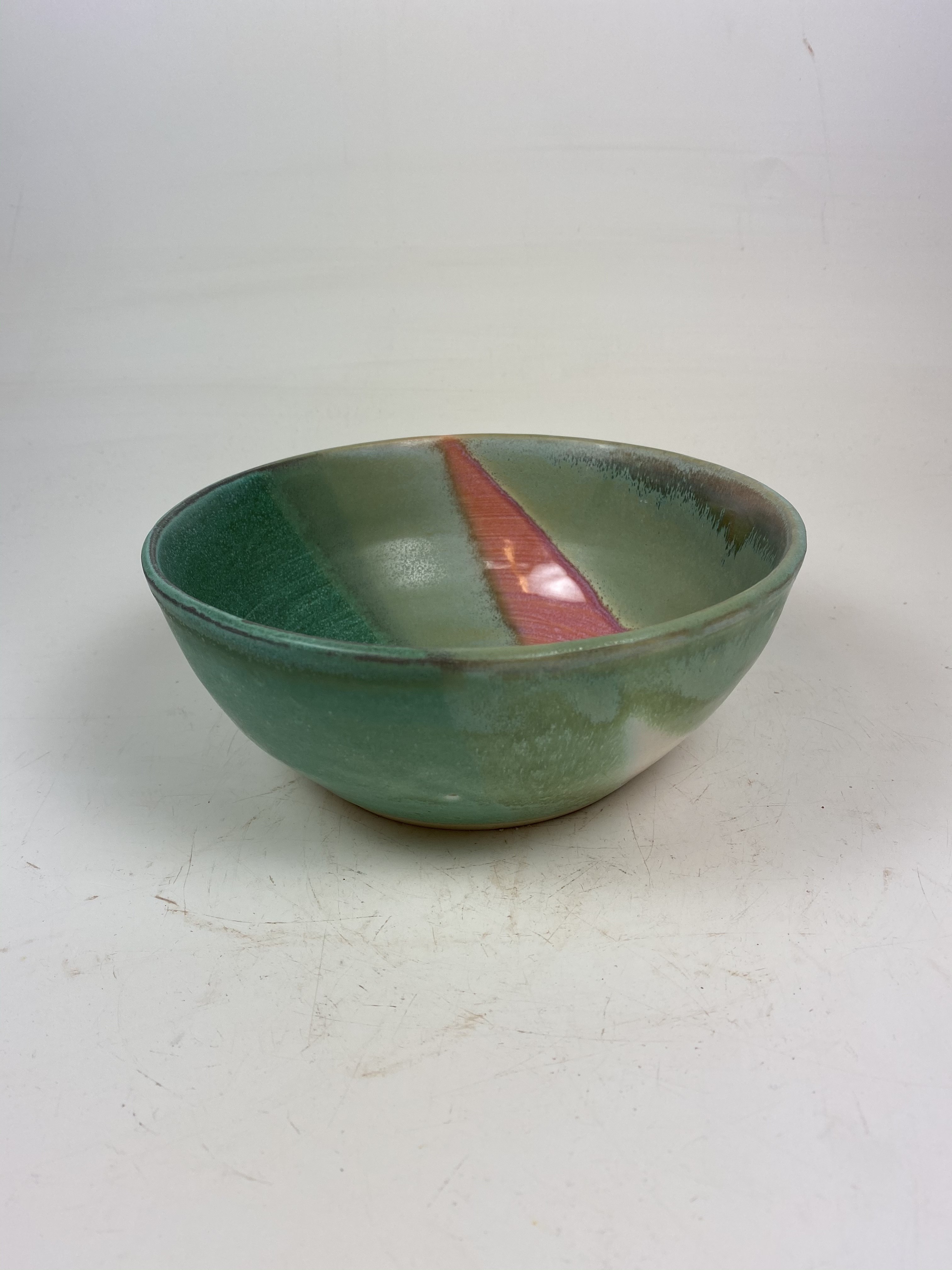 Wheel-thrown bowl with green and copper glaze